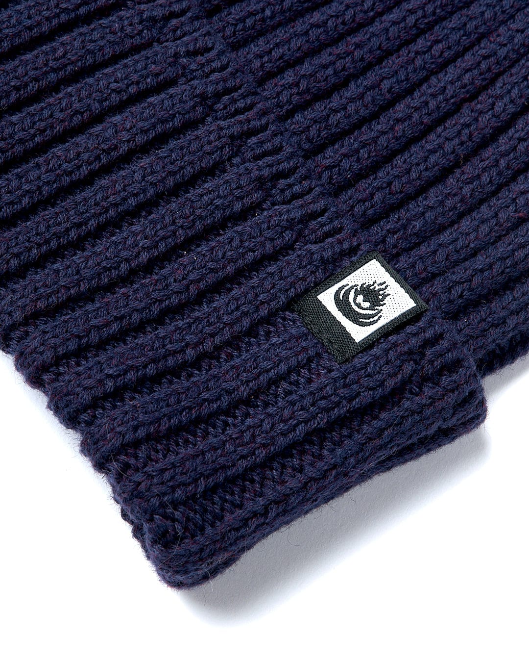 A Maine - Fisherman Beanie - Dark Blue beanie with a Saltrock logo on it.