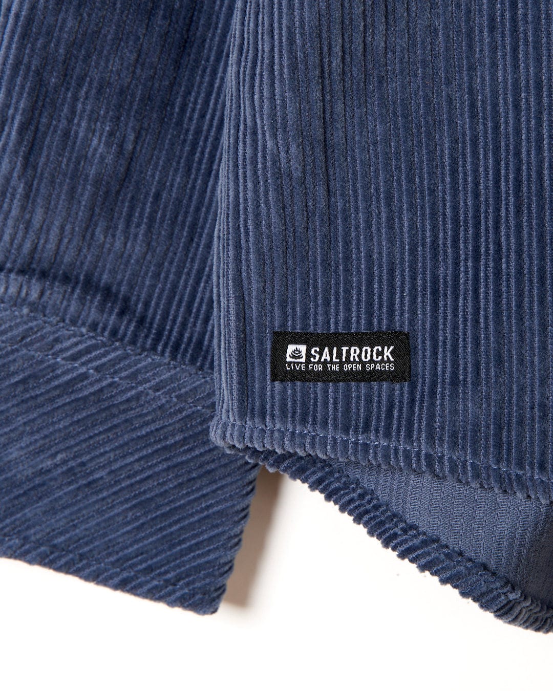 A Saltrock blue corduroy Ace - Mens Long Sleeve Shirt with front chest pockets and a label on it.
