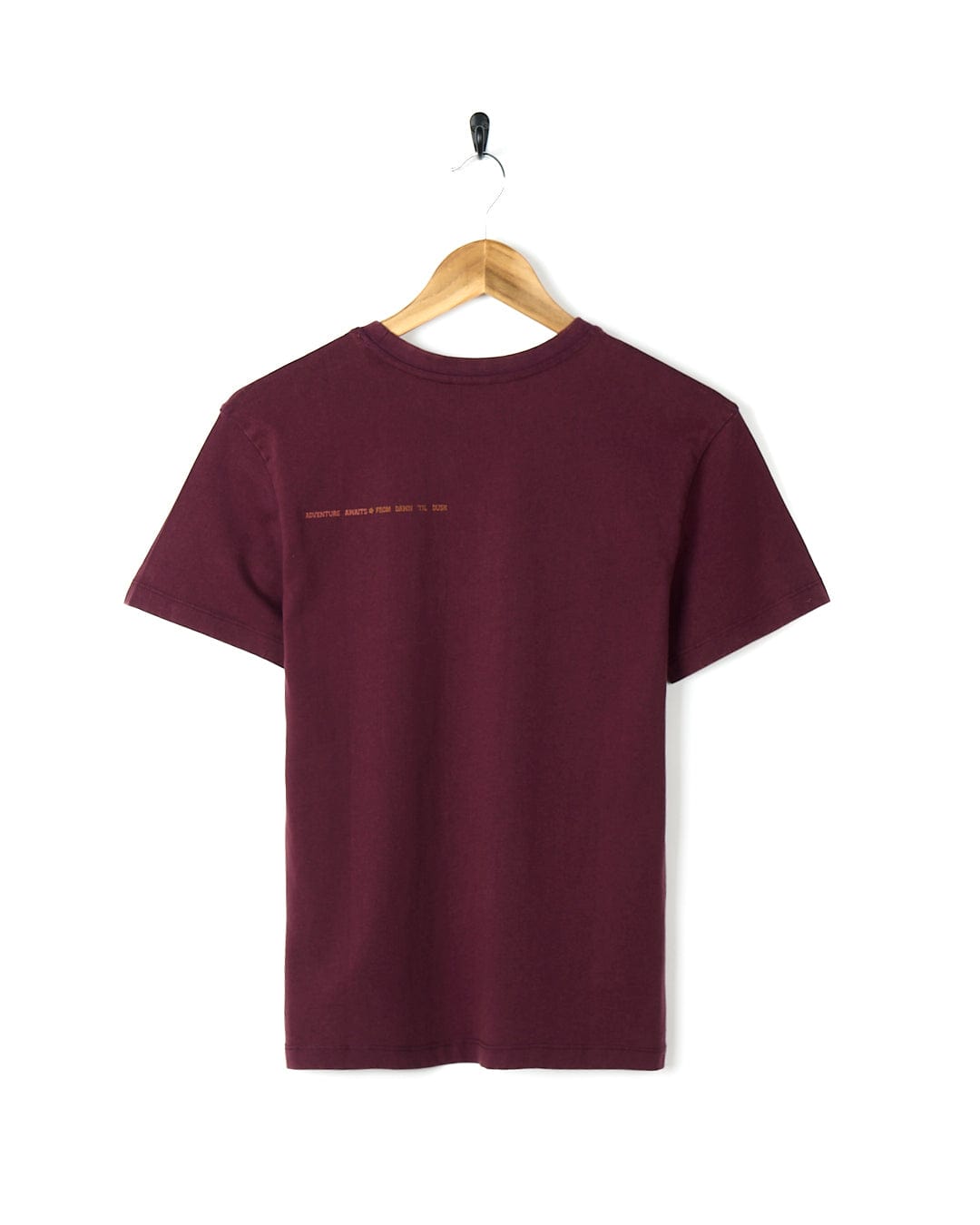 A Saltrock Adventure Awaits - Kids Short Sleeve T-Shirt - Dark Purple hanging on a wooden hanger.