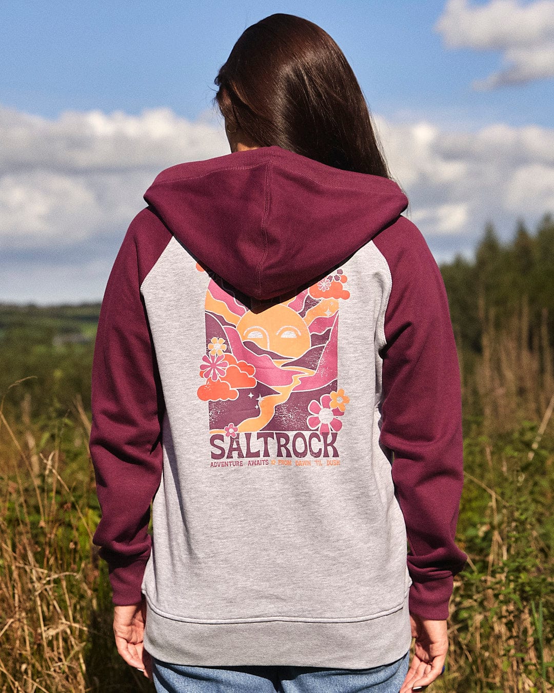 The back of a woman wearing an Adventure Awaits - Womens Zip Hoodie - Light Grey by Saltrock.