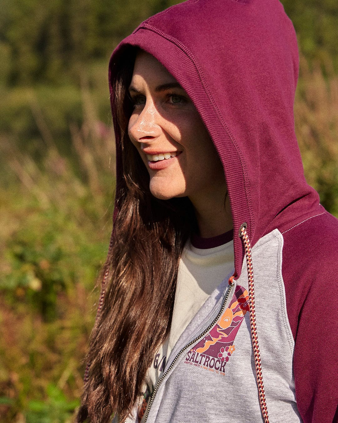 A woman wearing a cozy Adventure Awaits - Womens Zip Hoodie - Light Grey Saltrock hoodie enjoys the outdoors.