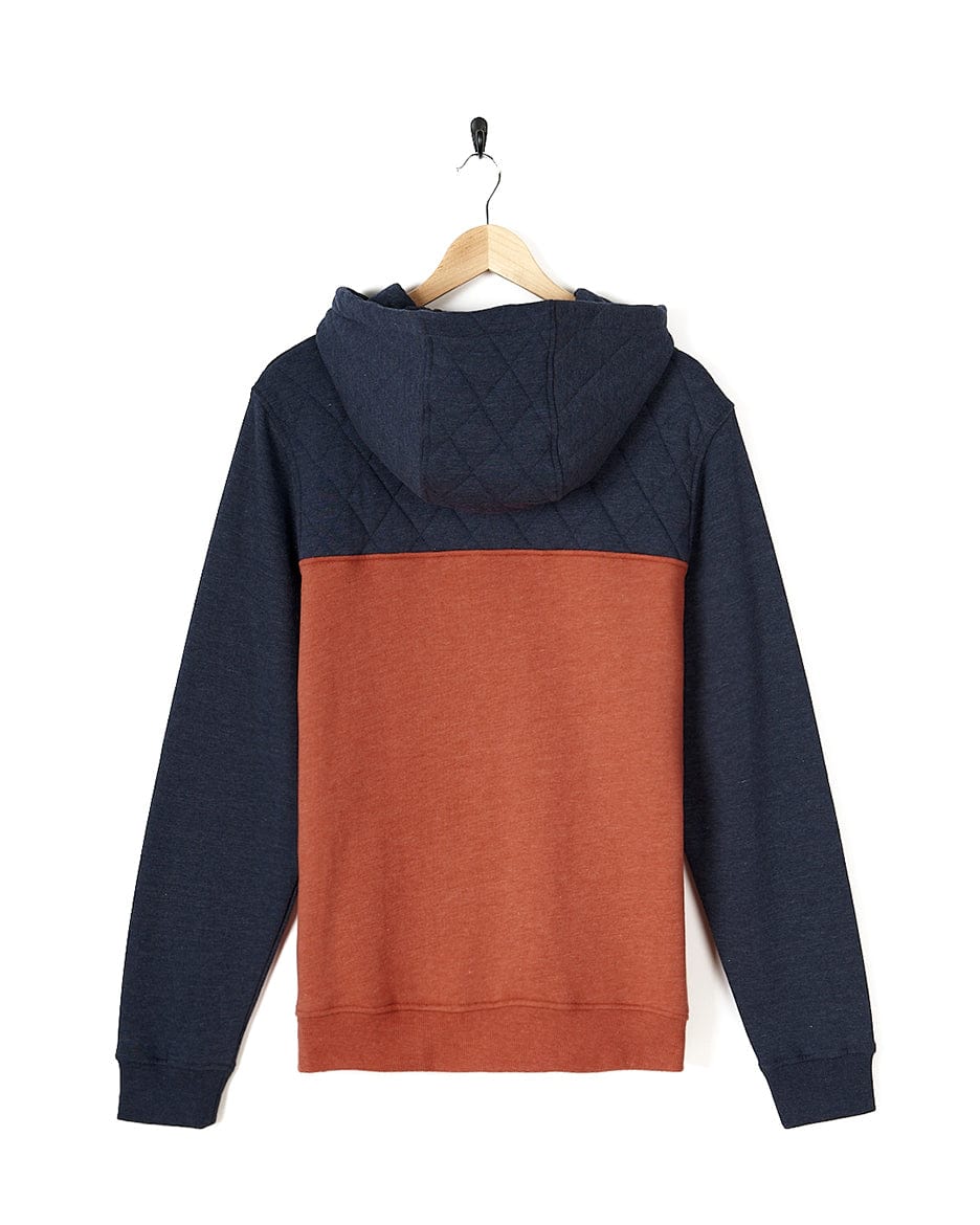 A Saltrock blue and orange Aiken - Mens 1/4 Neck Hoodie hanging on a hanger.