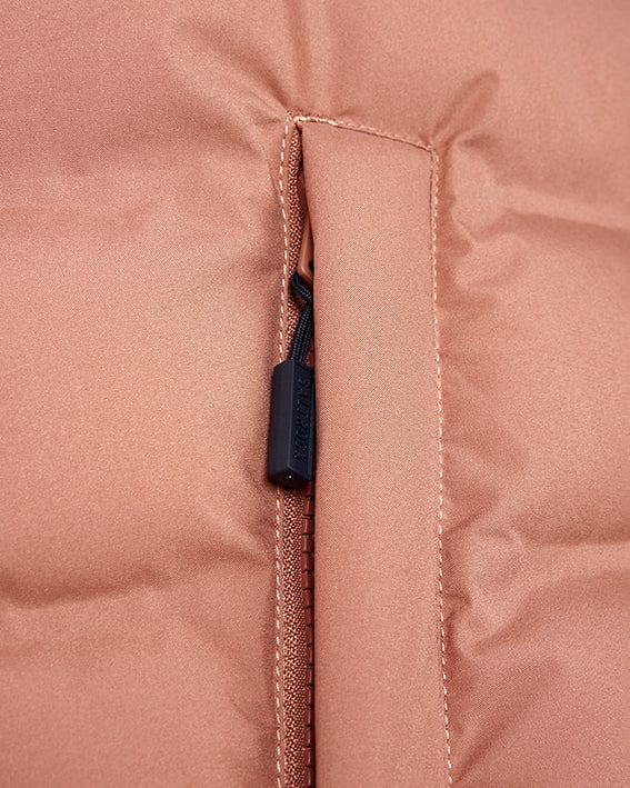 A close up of a Saltrock women's pink puffer jacket with a detachable hood and zipper.