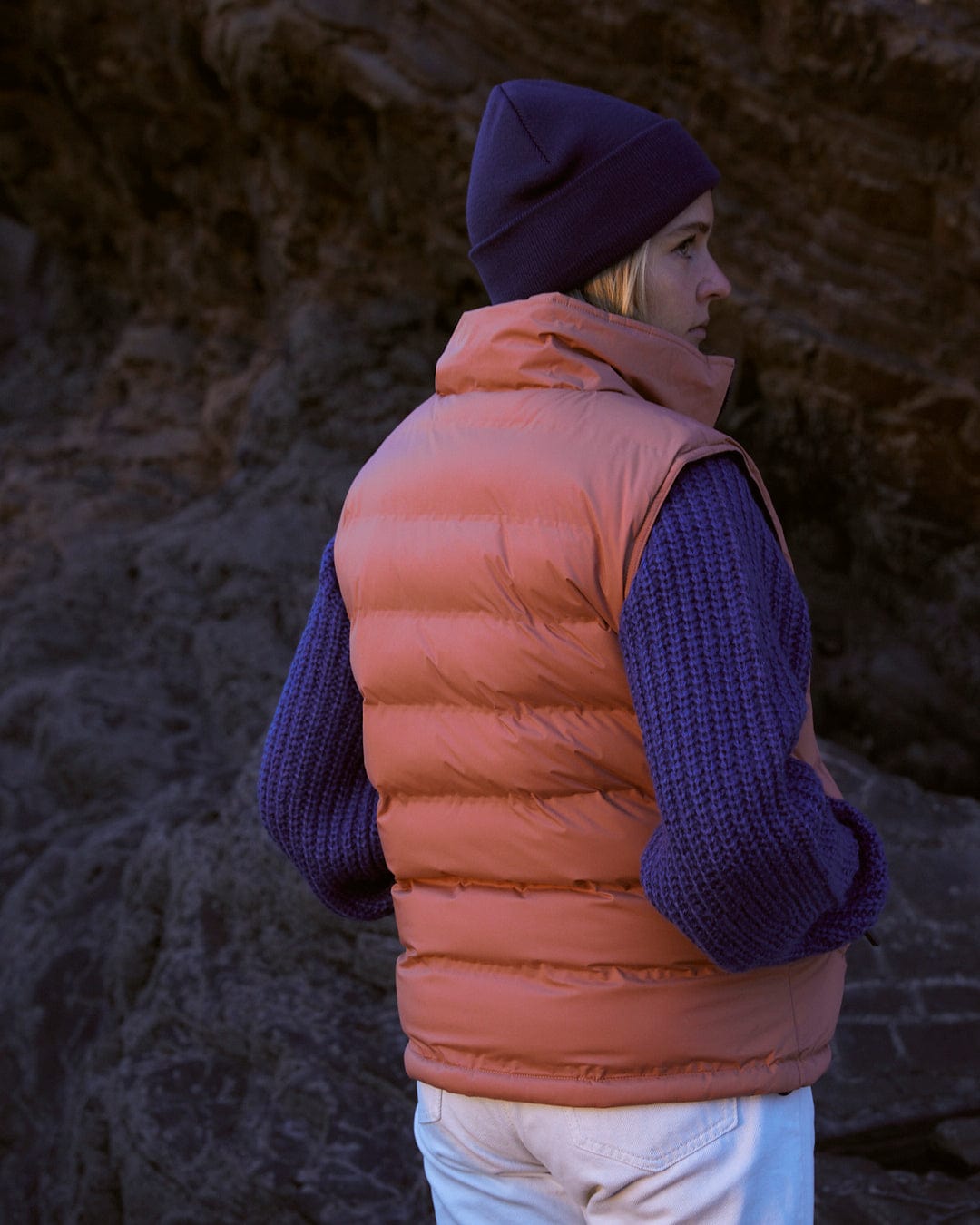 A woman wearing a Saltrock Astra - Womens Reversible Padded Gilet - Blue/Pink.