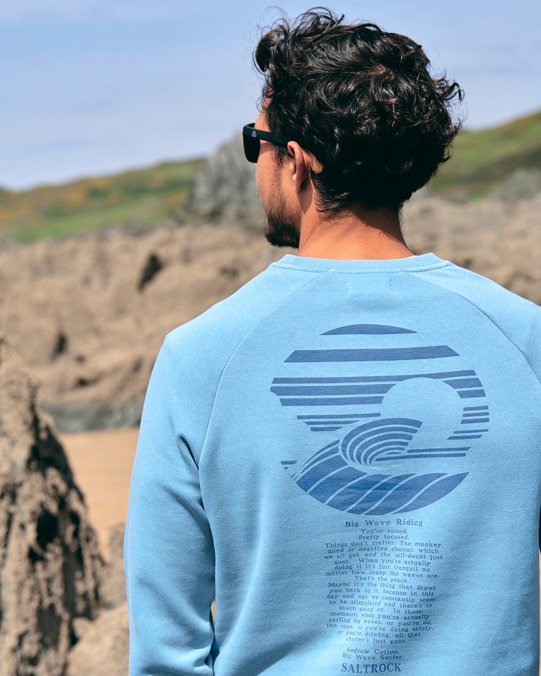 The back of a man wearing Saltrock sunglasses and an Atlantic - Mens Crew Sweat - Light Blue sweatshirt.