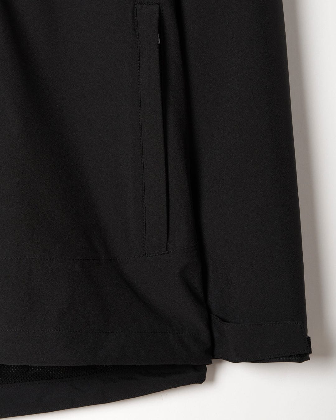 Close-up of a Saltrock Aubrey - Womens Waterproof Jacket in Black with detailed stitching and a mesh hem.