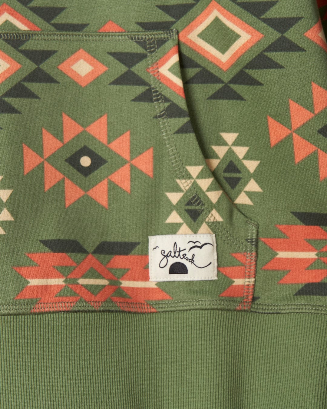 A green hoodie with an Aztec Santano print pattern by Saltrock.