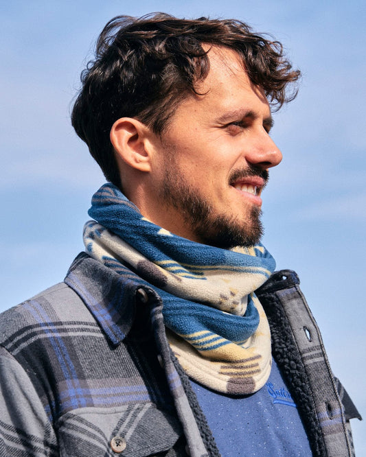 A man wearing a stylish Saltrock Aztec - Snood - Blue, perfect for winter days.