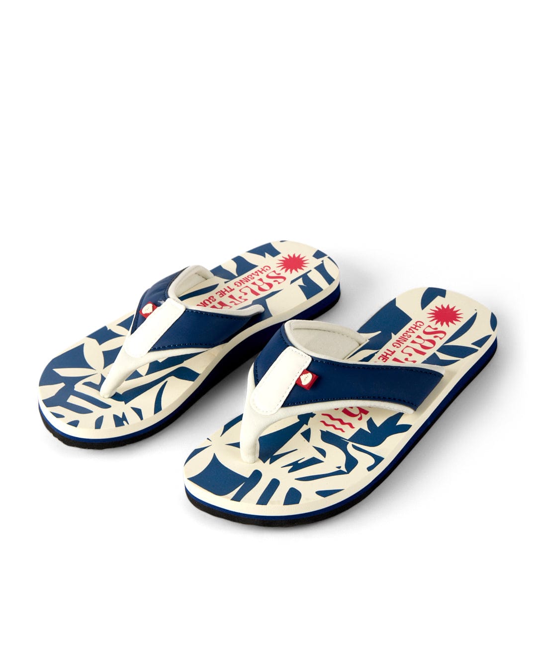 Saltrock Balance Women's Flip Flops in blue and white with a floral pattern and red text on the footbeds, featuring a grippy outsole, shown side by side on a white background.