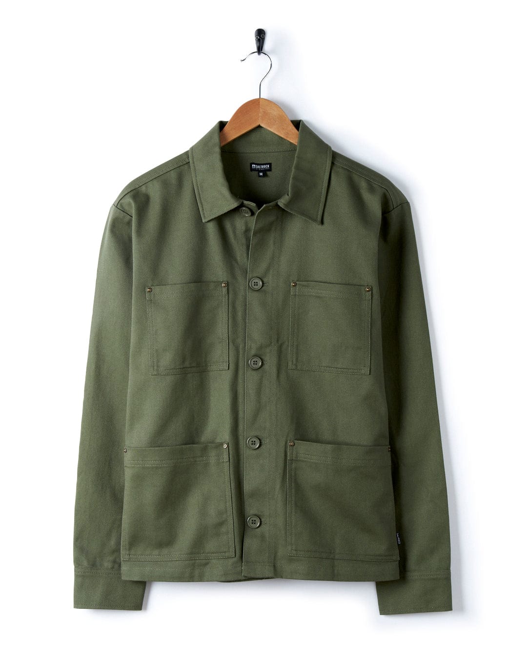A Saltrock Barden - Womens Lightweight Utility Jacket - Dark Green hangs on a hanger.