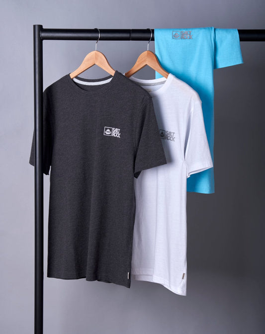 Three Saltrock Original Mens Short Sleeve T-Shirts in Light Blue with crew necklines hanging on a rack against a gray background, featuring a black, white, and blue shirt each with a logo on the chest.