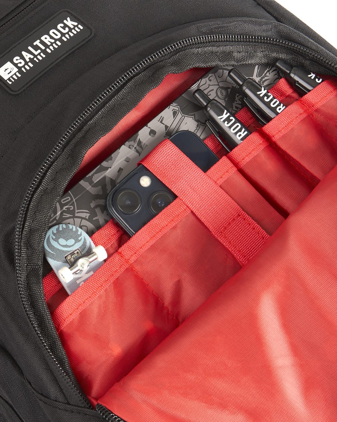 A Saltrock Boardwalk - Backpack - Black with a cell phone inside.
