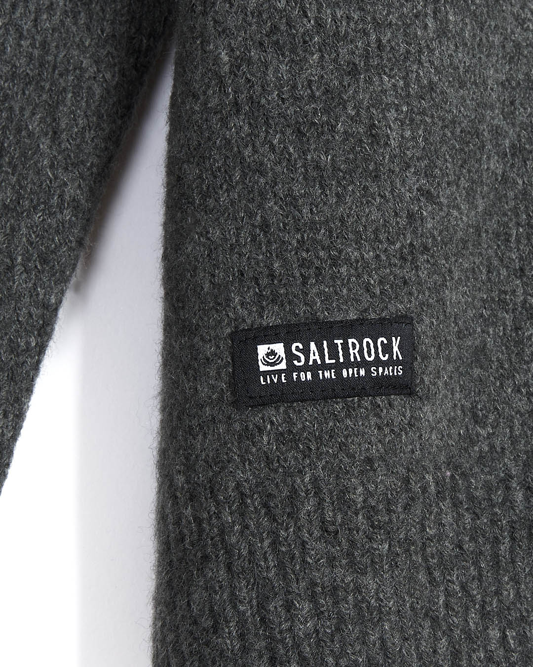A close up of the Saltrock branding logo on a Bowen - Mens Knitted Crew - Grey sweater, perfect for layering.