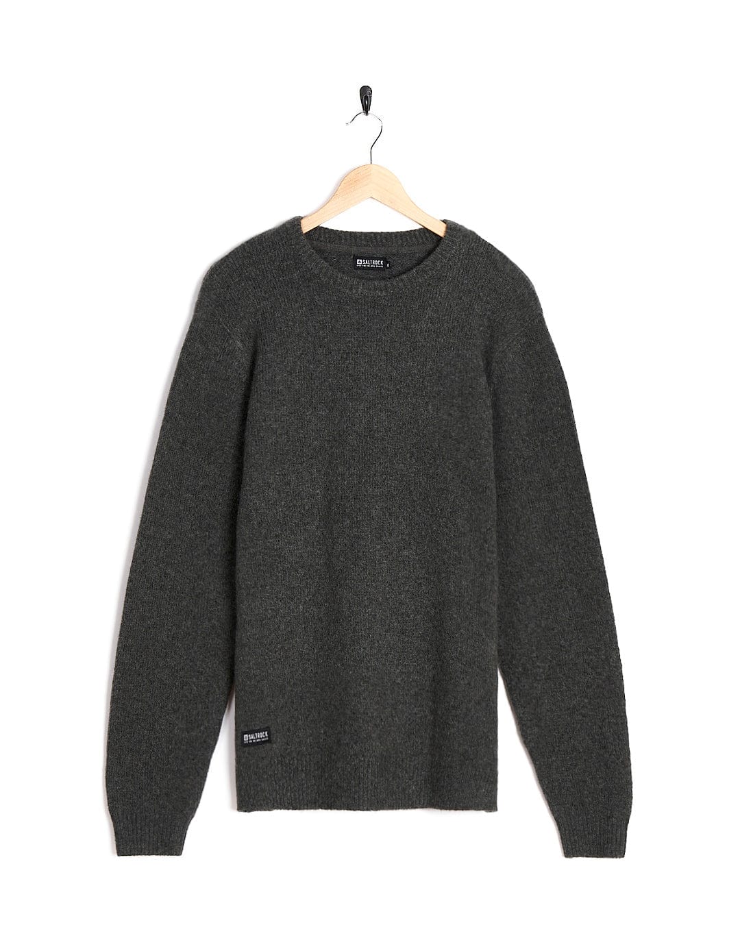 An elegant grey Saltrock sweater, the Bowen Mens Knitted Crew, gracefully hangs on a hanger, perfect for layering.