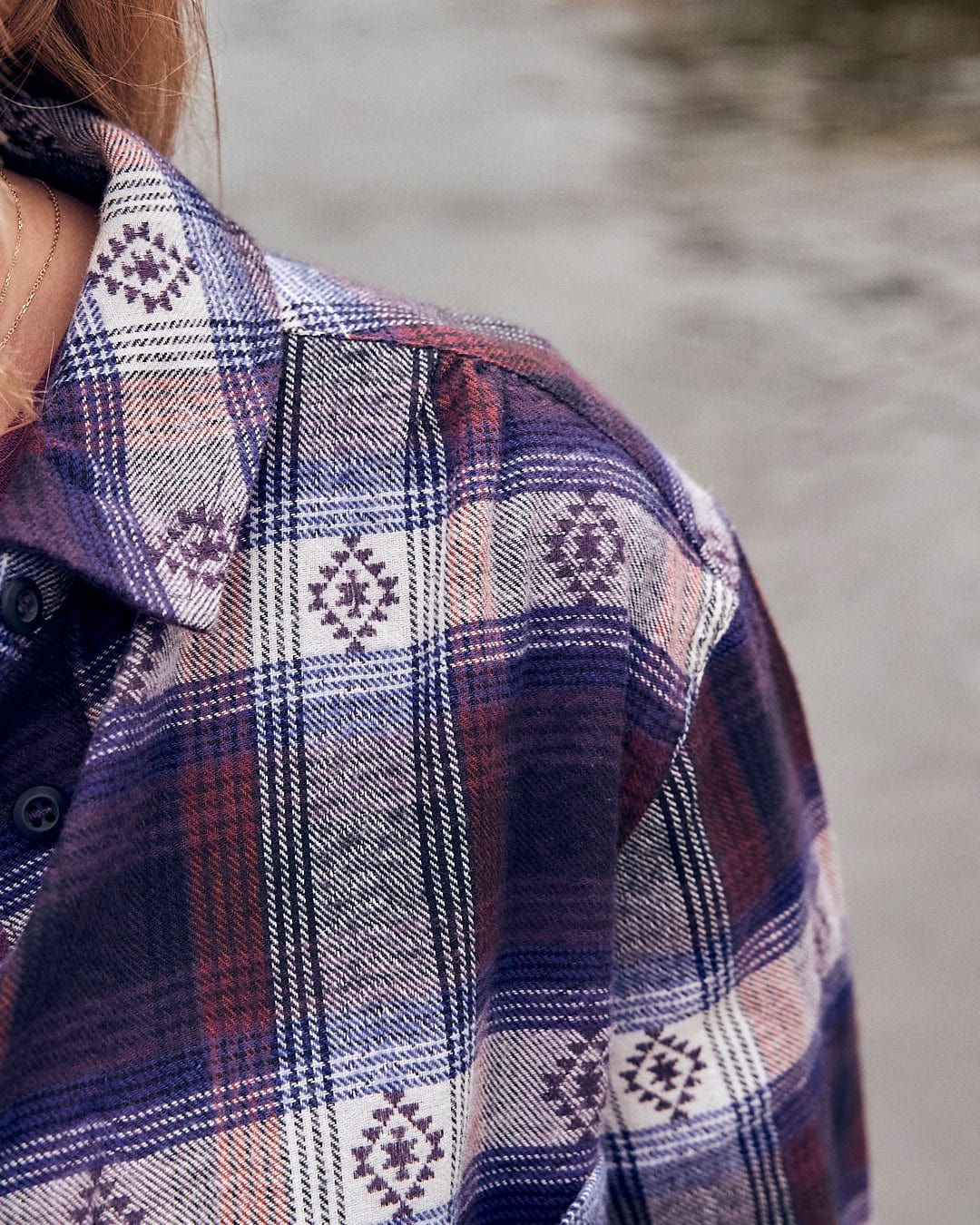 A woman wearing a Saltrock Camille - Womens Jaquard Check Boyfriend Shirt - Purple near a river.