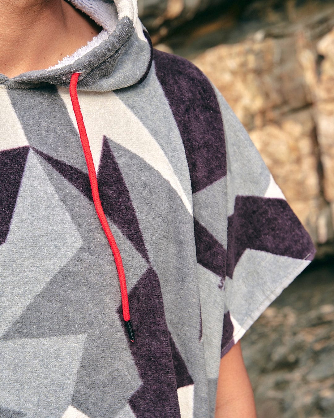 A man wearing a Saltrock Geo Camo - Changing Towel - Grey hoodie.