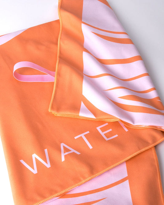 A lightweight Cold Water Club Microfibre Towel - Orange with the word "water" on it by Saltrock.