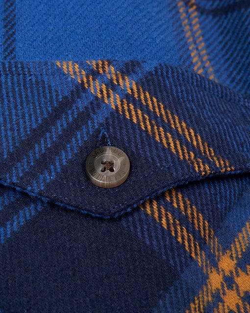 A button on a Saltrock Colter - Mens Hooded Shirt - Blue.