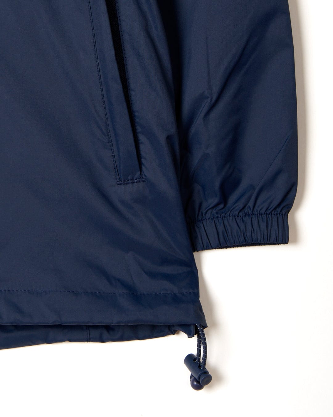 Close-up of a Saltrock Cooper - Womens Packable Waterproof Jacket - Blue sleeve with elastic cuff and adjustable drawstring on a white background.