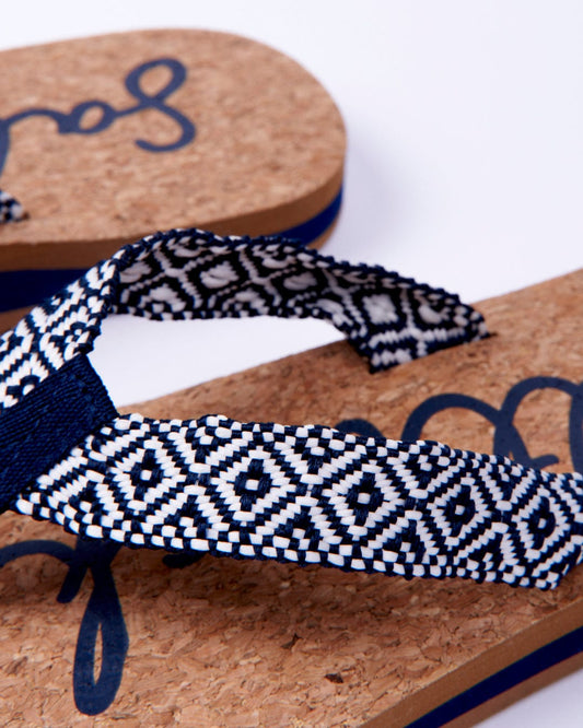 Close-up of a pair of Saltrock Corklife Womens Flip Flops in Navy with cork soles and printed webbing toe straps.