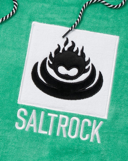 Embroidered branding of "Corp Changing Towel - Green" on a textured, absorbent cotton towelling fabric by Saltrock.