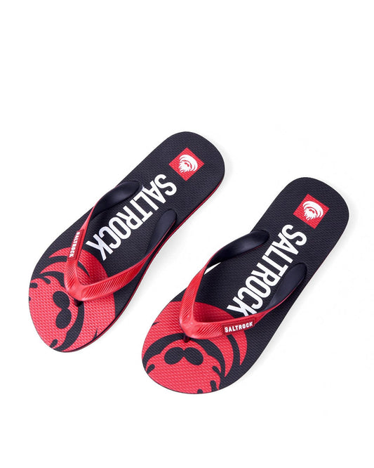 A pair of Saltrock Corp Flame flip-flops with red straps and a black and red patterned sole, featuring Saltrock branding on both the strap and sole.