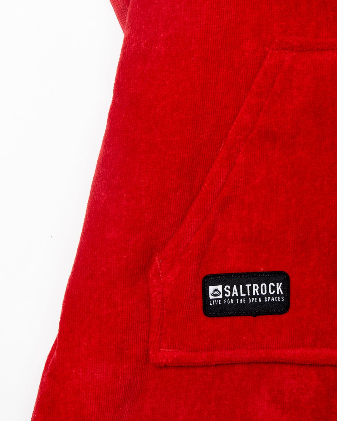 Close-up of a red Saltrock Corp - Kids Changing Robe with the brand label visible on the front pocket area.