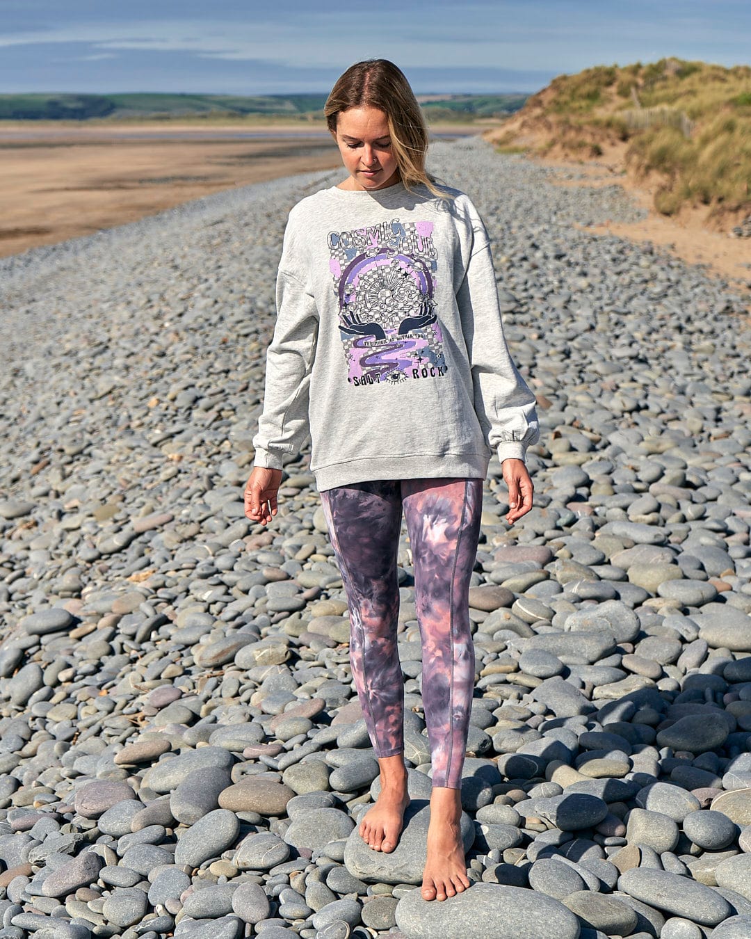 A woman rocking a comfortable Cosmic Soul Womens Longline Sweat - Light Grey and leggings on the beach. Brand Name: Saltrock