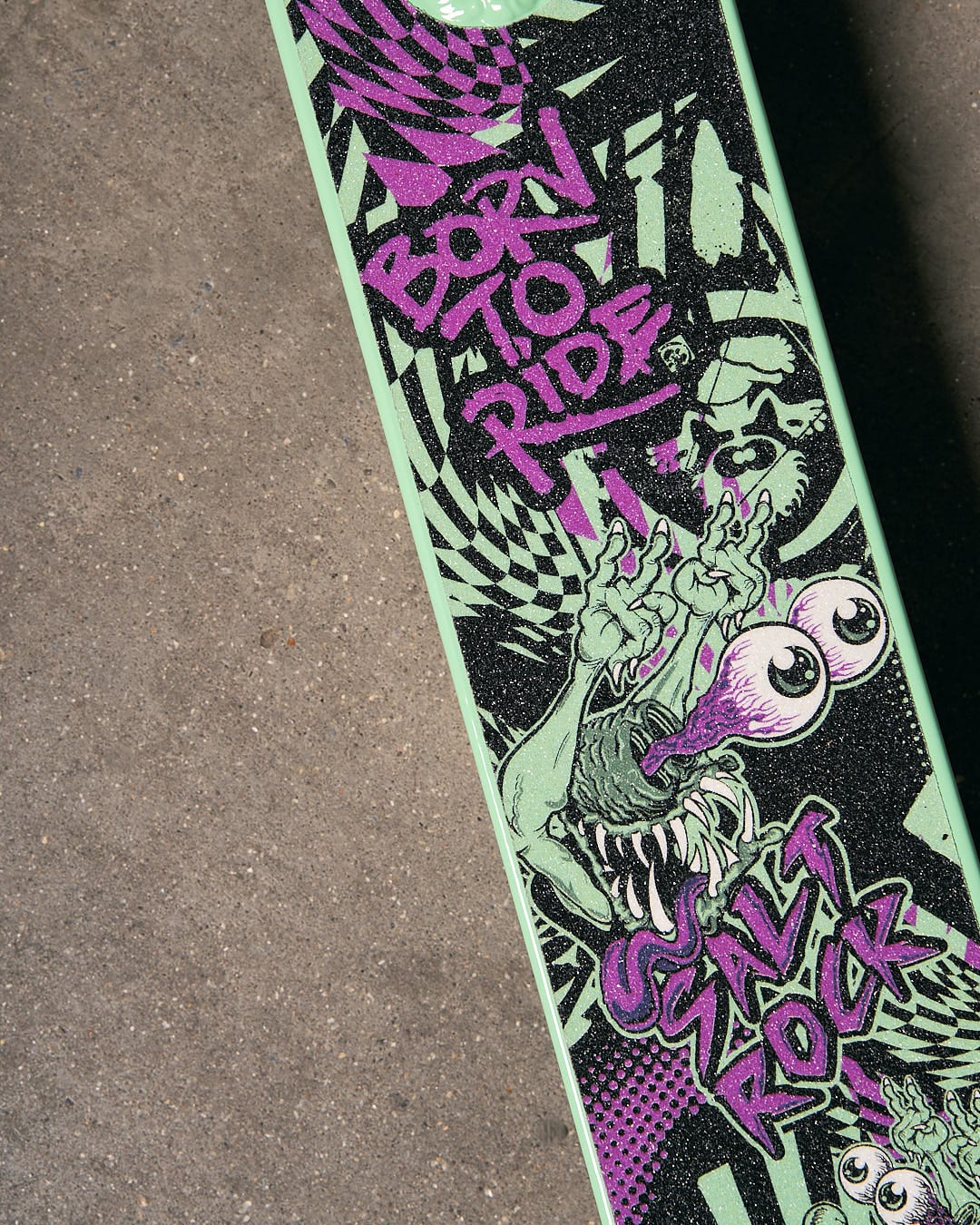 A Creeper Stunt Scooter - Turquoise by Saltrock with a green and purple design on it.