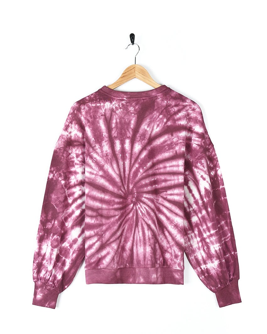 A trendy Dawn - Women's Tie Dye Sweatshirt - Pink with Saltrock branding hanging on a hanger, perfect for a fashionista.