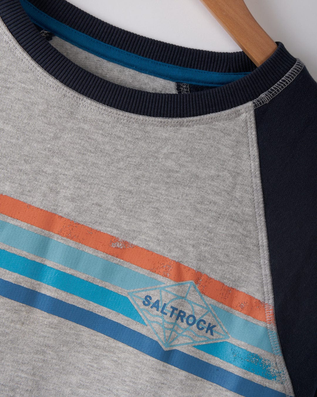 The Saltrock Dimensions Stripe Men's Sweat in blue and grey features a crew neck, raglan sleeves, blue and orange stripes, and a bold Saltrock logo on the chest.
