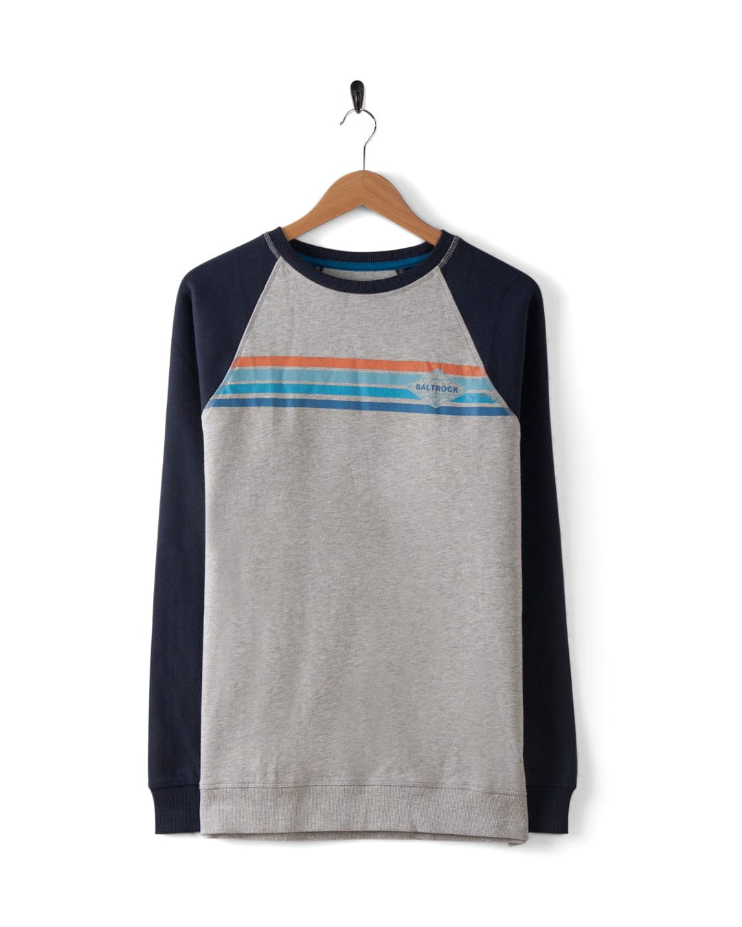 The Saltrock Dimensions Stripe Men's Sweat in blue/grey features navy raglan sleeves, a light gray body, blue and orange chest stripes, and a subtle Saltrock logo—shown here hanging on a wooden hanger.