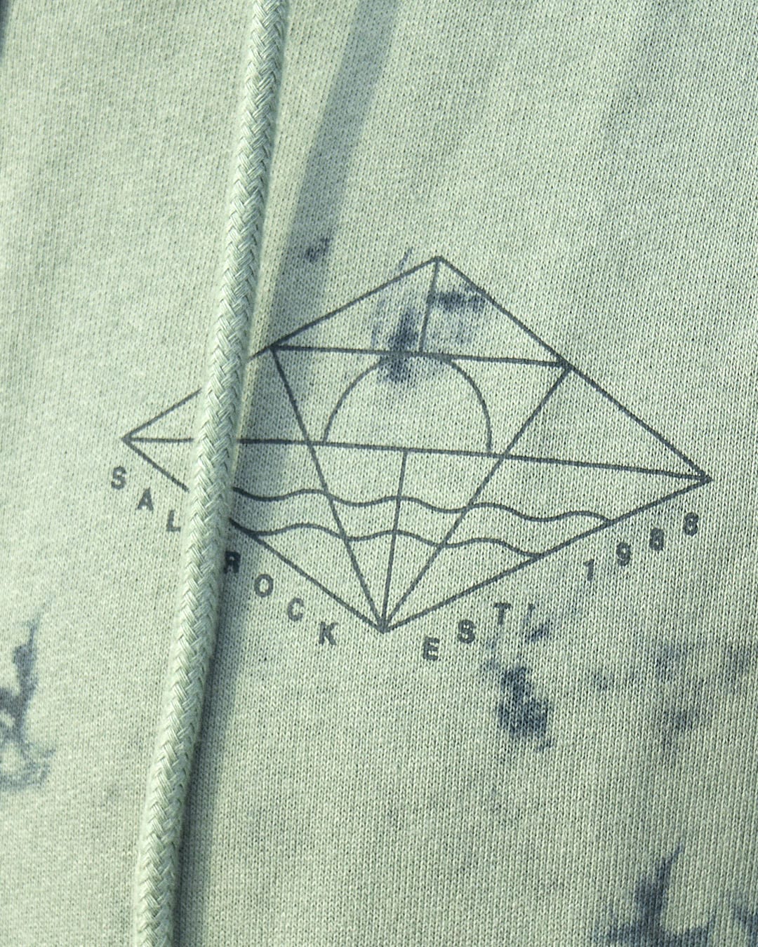 A close up of a green Saltrock Dimensions - Mens Zip Tie Dye Hoodie with Saltrock graphics.