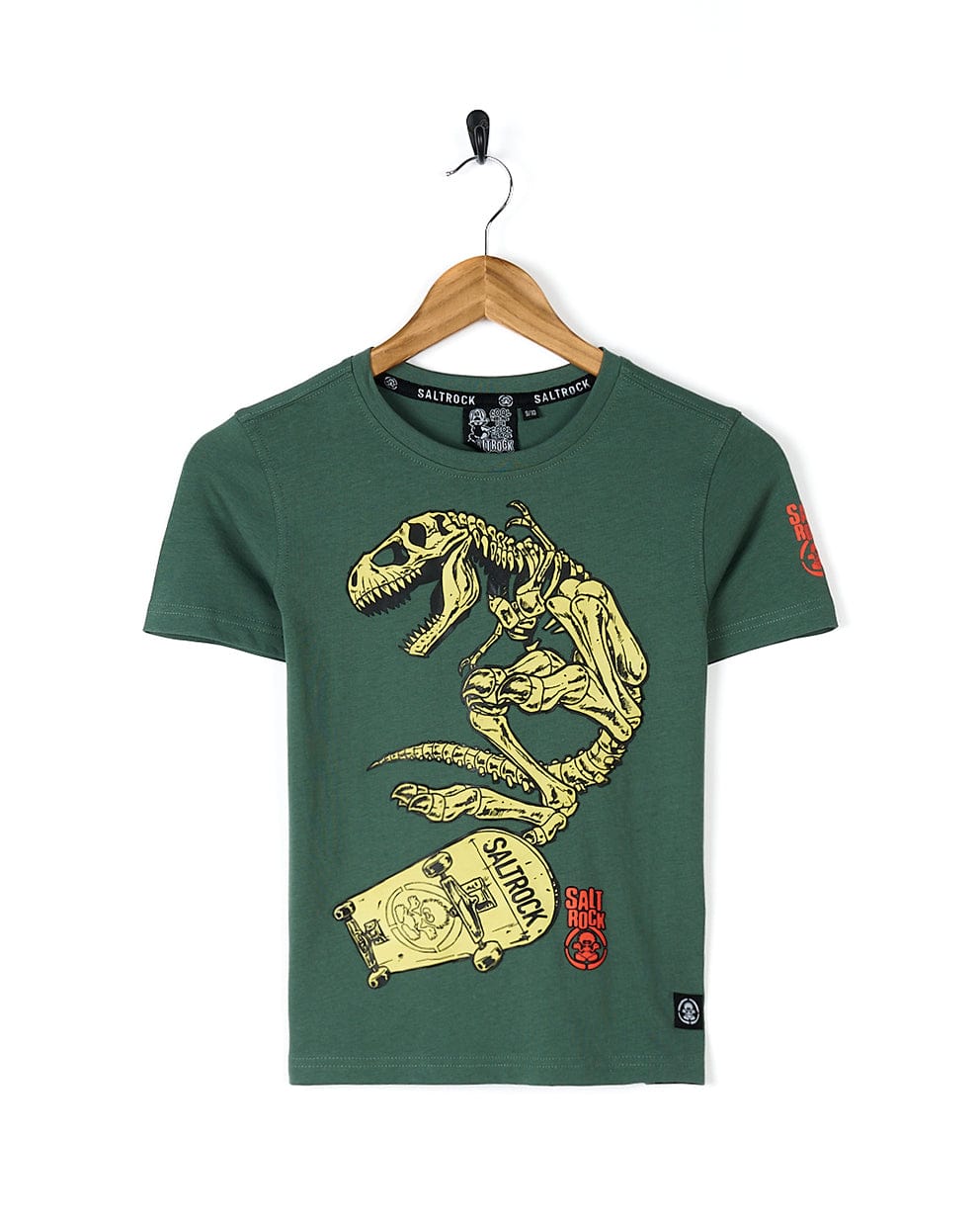 A cool and stylish Saltrock Dinosk8 - Kids Short Sleeve T-Shirt - Green featuring a dinosaur riding a skateboard.