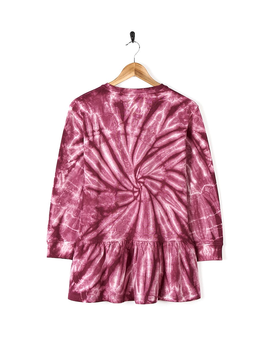 A cool and stylish Effie - Kids Tie Dye Sweatdress - Pink by Saltrock hanging on a hanger.