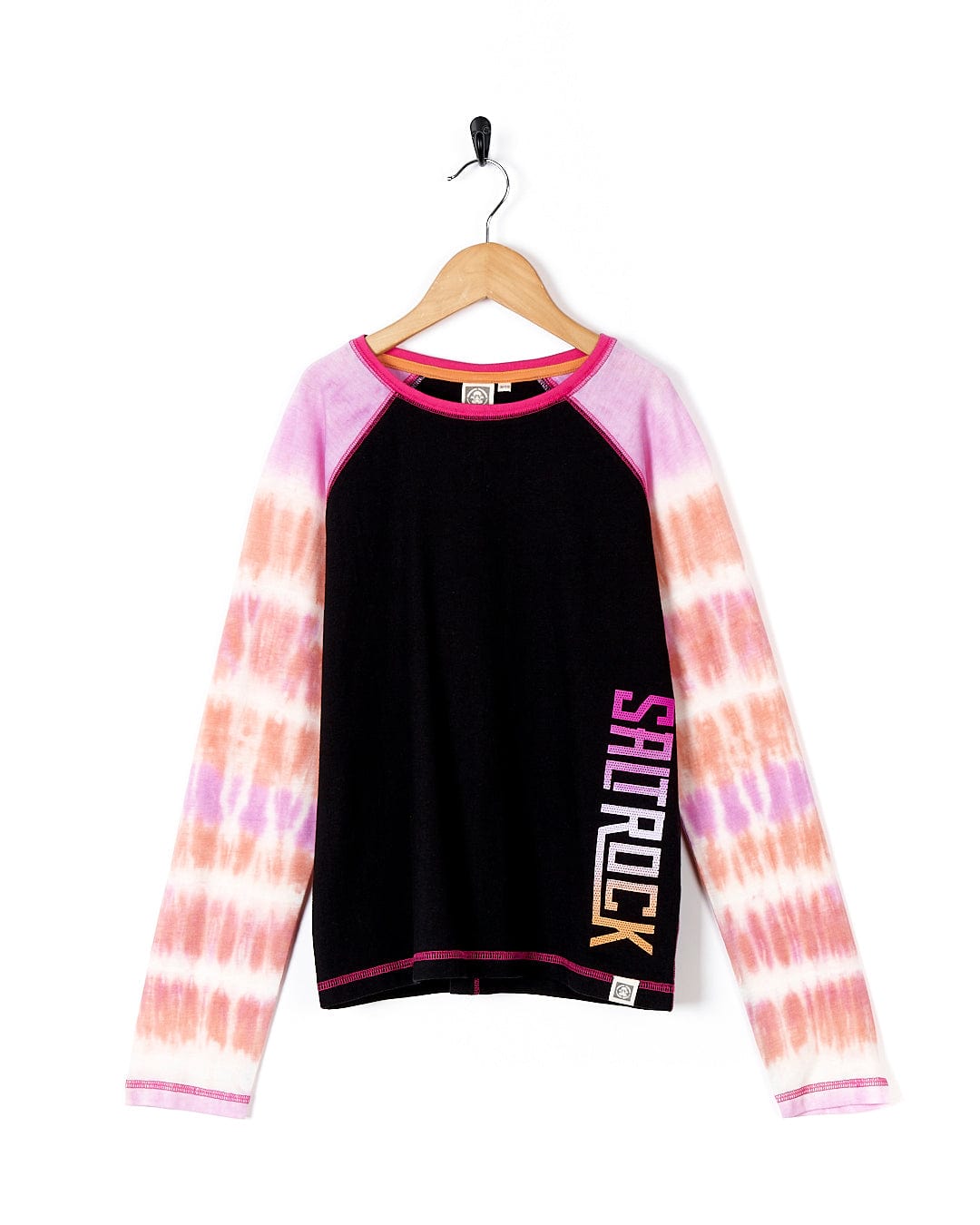 A girl's Elektra Tex - Kids Tie Dye Long Sleeve T-Shirt - Black, by Saltrock, hanging on a hanger.