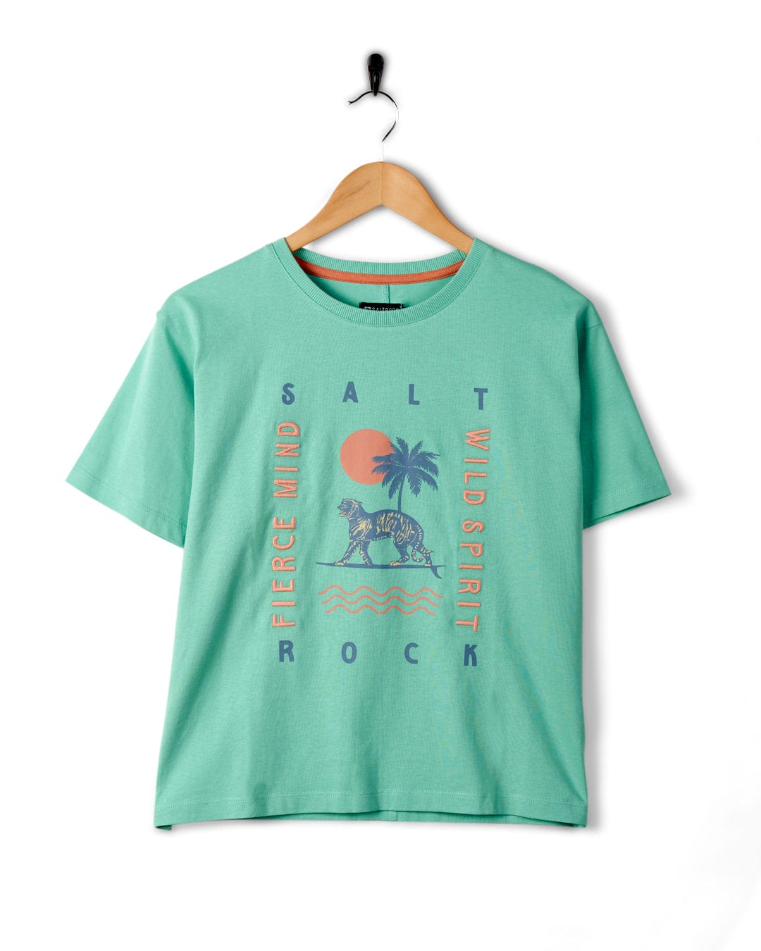 A Fierce Mind - Womens Boxy T-Shirt in Green with a tropical design and Saltrock embroidered branding hanging on a white wall.