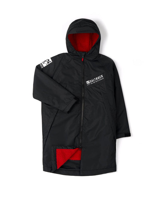 Saltrock branded recycled Kids Four Seasons Changing Robe - Black/Red, featuring red interior and patch detail, displayed against a white background.