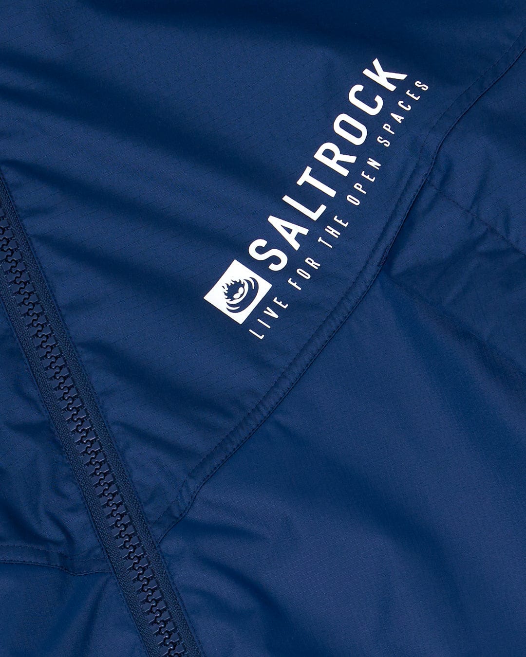 Close-up of a Saltrock Recycled Four Seasons Changing Robe - Blue with the brand logo and slogan visible.