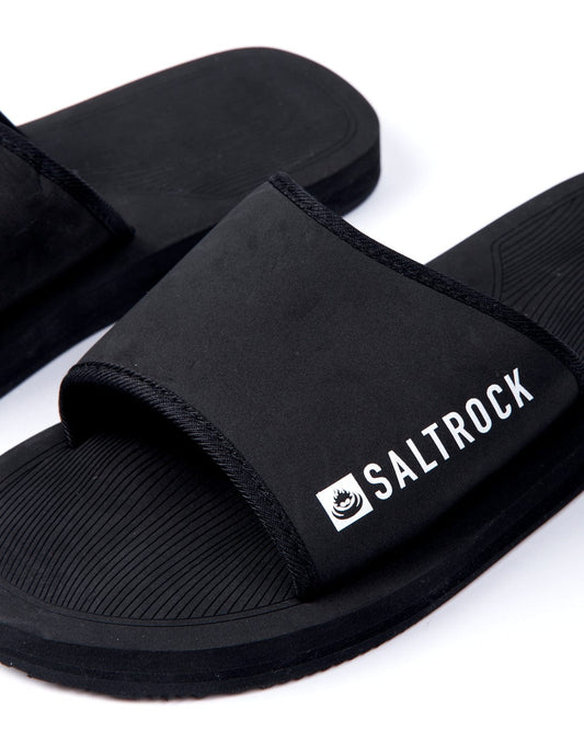 A pair of black Saltrock Ghost unisex sliders with Saltrock branding visible on the strap, set against a white background.