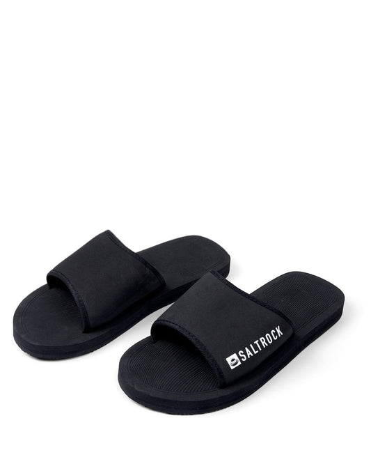 A pair of black Saltrock Ghost - Unisex Sliders with cushioned soles, isolated on a white background.
