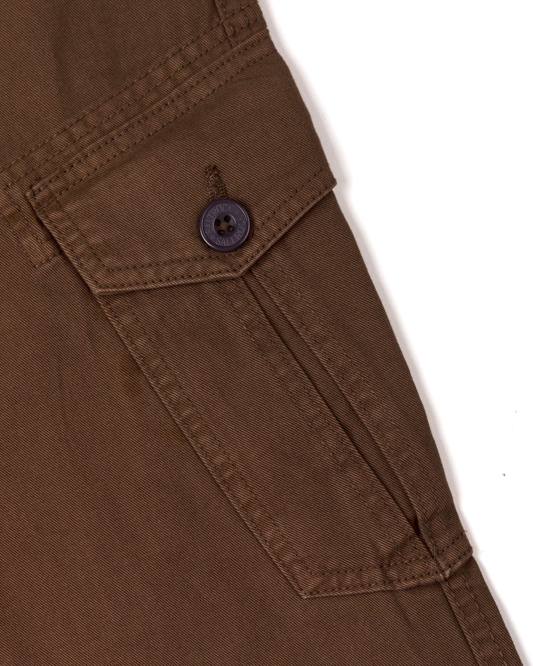 Close-up of a Saltrock Godrevy 2 - Mens Cargo Trousers - Brown pant leg featuring cargo patch pockets.