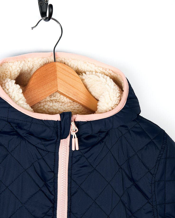 A Saltrock Hadleigh - Reversible Coat - Blue/Cream with fur lining hanging on a hanger.