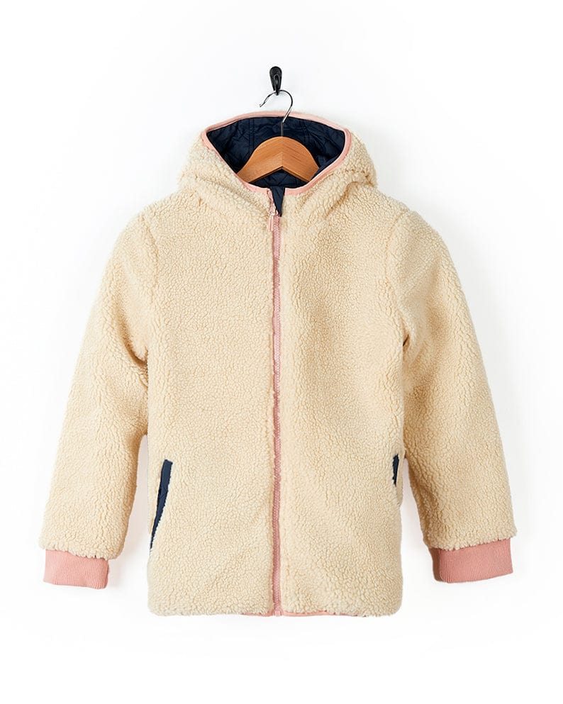 A Saltrock Hadleigh - Reversible Coat - Blue/Cream with a fur lining hanging on a hanger.