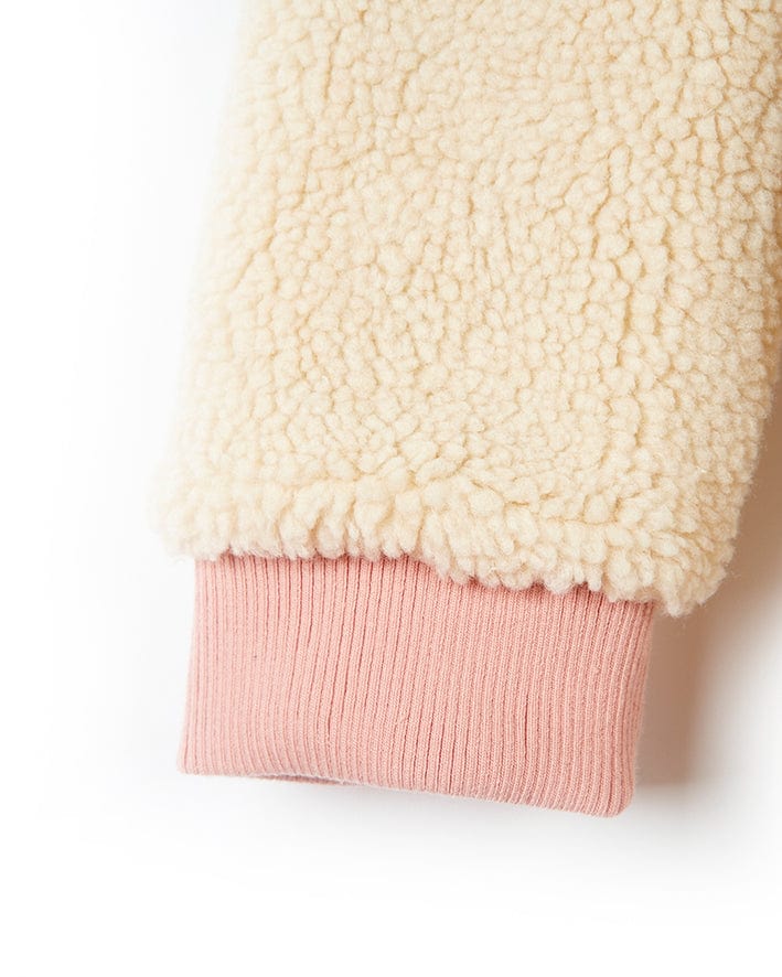 A blue and cream reversible Hadleigh sherpa jacket on a white surface. (Brand: Saltrock)