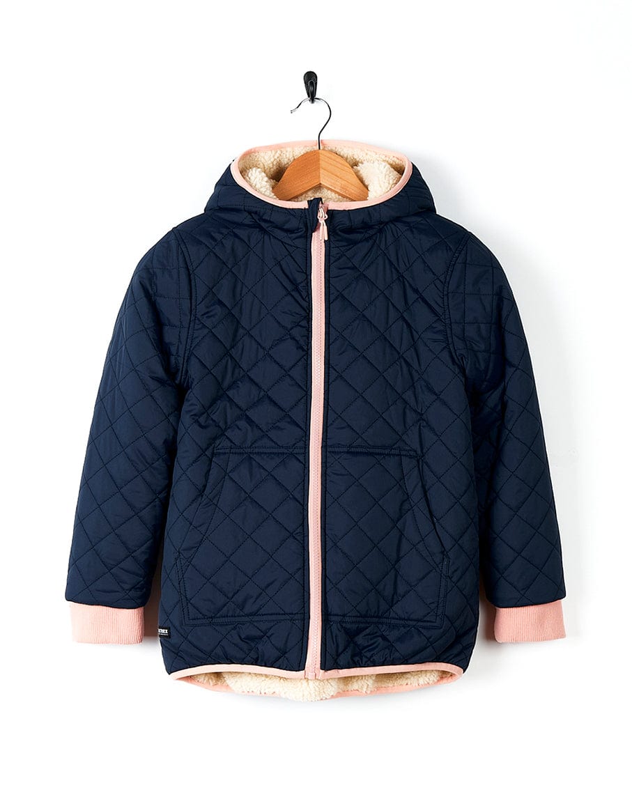 A Saltrock girl's Hadleigh - Reversible Coat - Blue/Cream with a navy outer shell and pink fur lining.