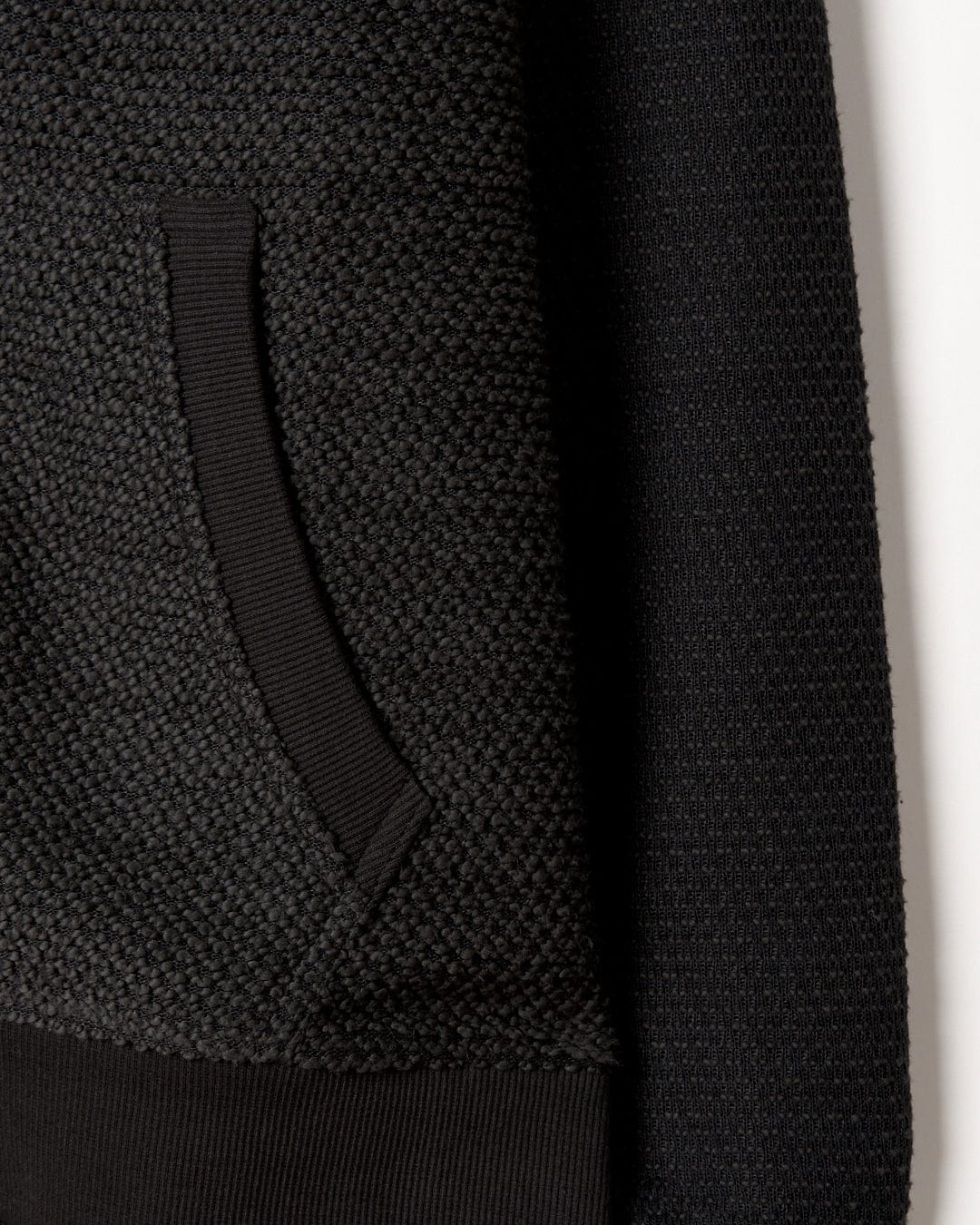 A close up of a Saltrock Hall - Borg Lined Hoodie in Black knit fabric.