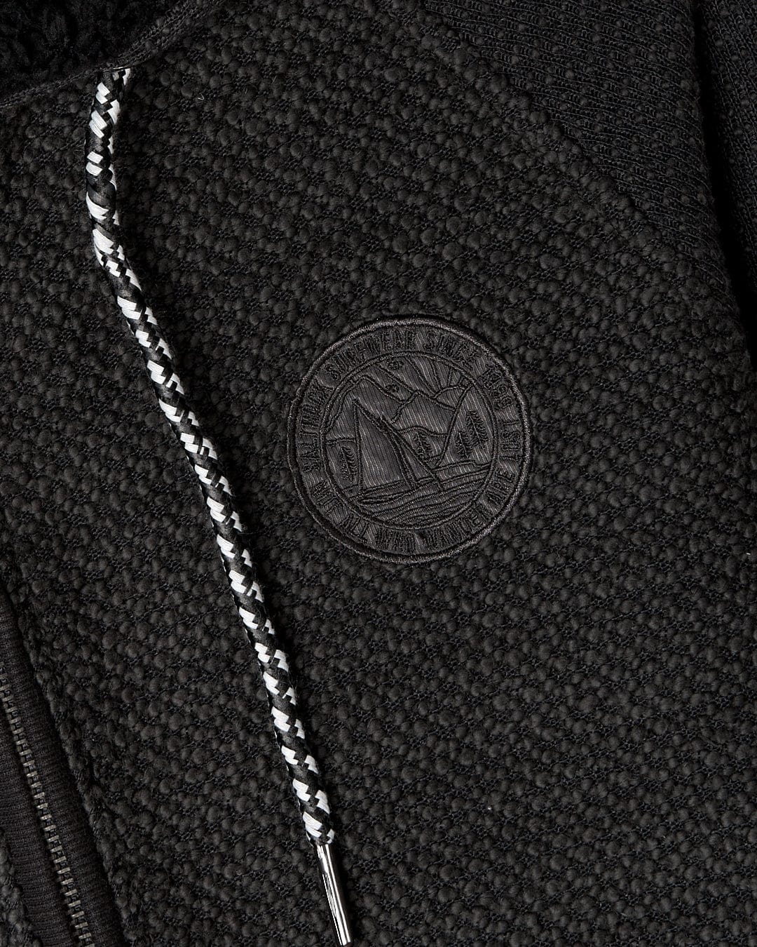 A close up of a Saltrock Hall - Borg Lined Hoodie in Black with a zipper.