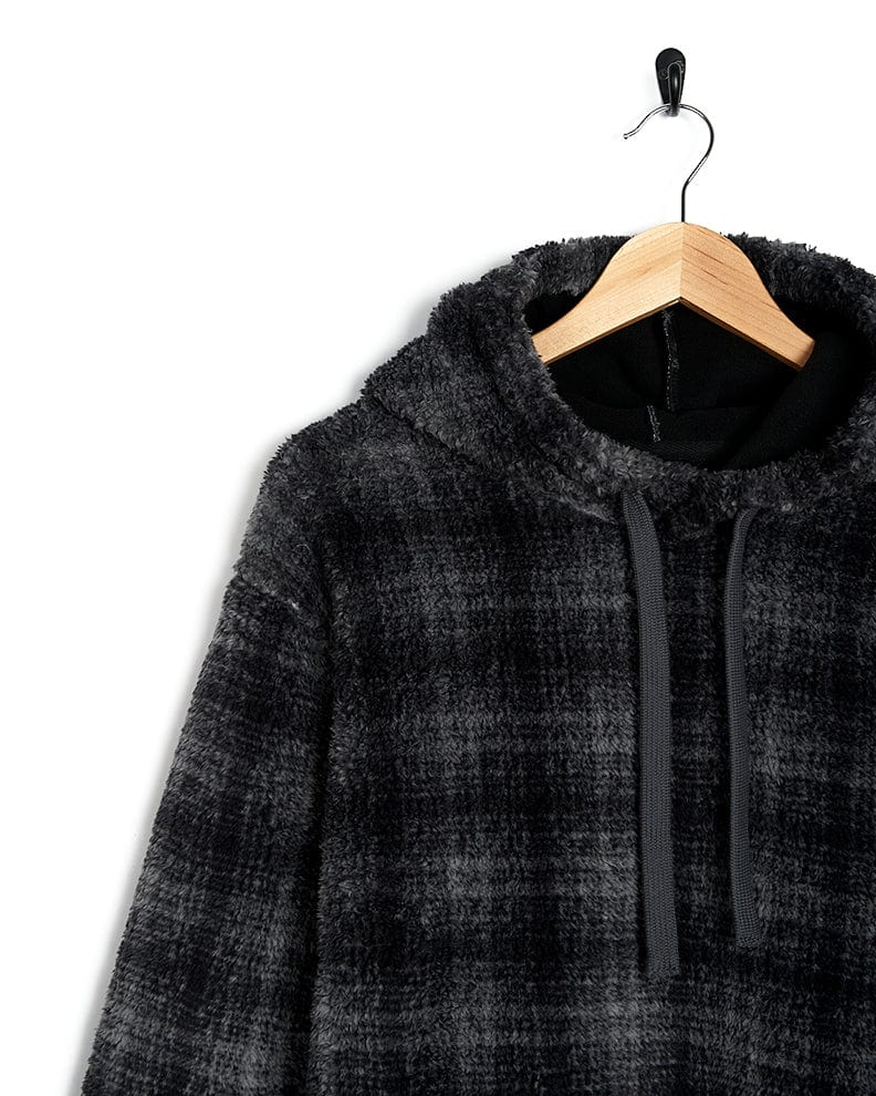 A black and grey plaid Halycon - Mens Fleece Hoodie - Dark Grey, made of fleece material and featuring Saltrock branding, hanging on a hanger.