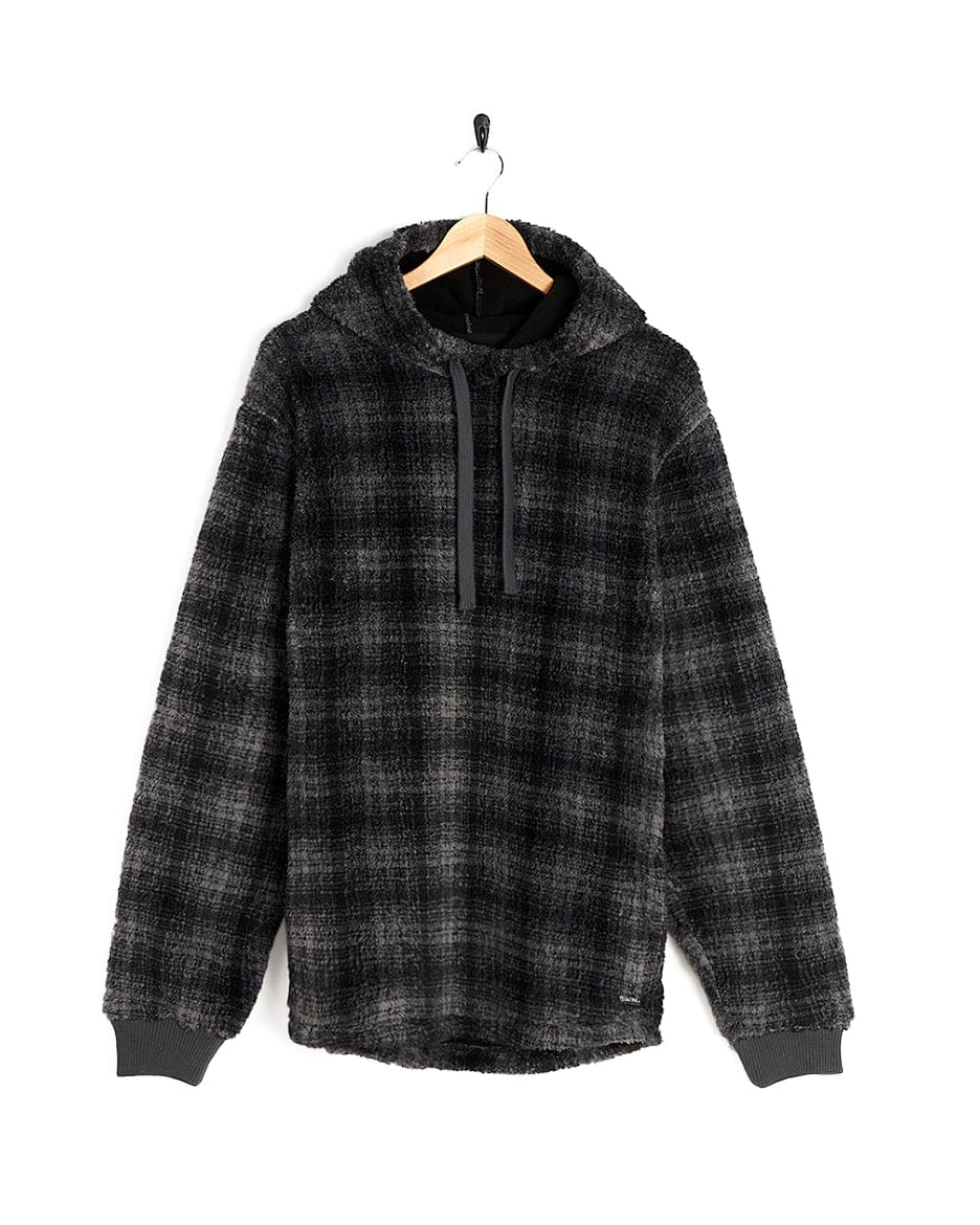 A black and grey Halycon - Mens Fleece Hoodie - Dark Grey with Saltrock branding, made of fleece material, hanging on a hanger.